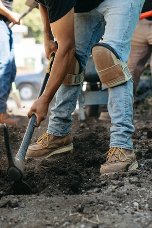 Person digging in the dirt with a shovel