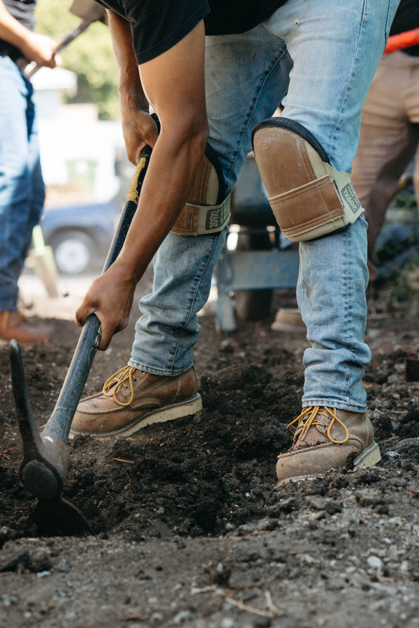 Person digging in the dirt with a shovel